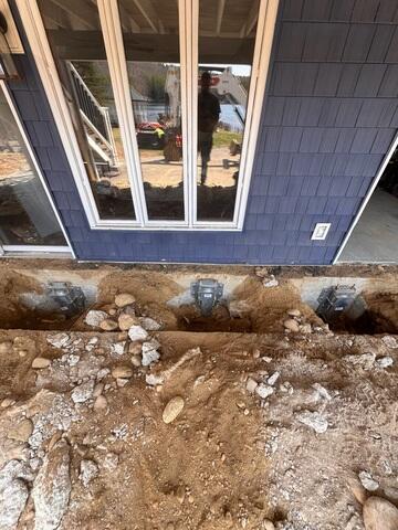 View of the helical piers installed beneath the deck section.