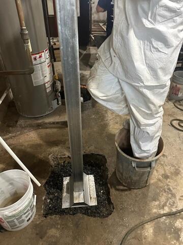 Heavy-duty steel SmartJack posts were then precisely cut to fit the height of the basement and positioned beneath the compromised beams.