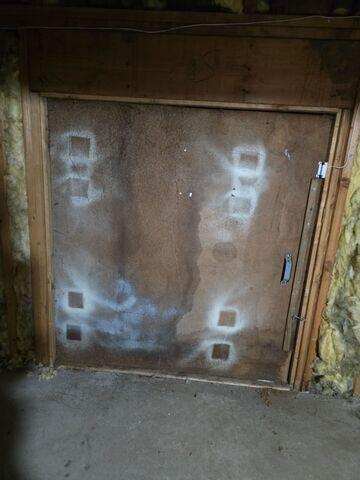 The door from the crawl space to the space underneath the three-season room, prior to our work.
