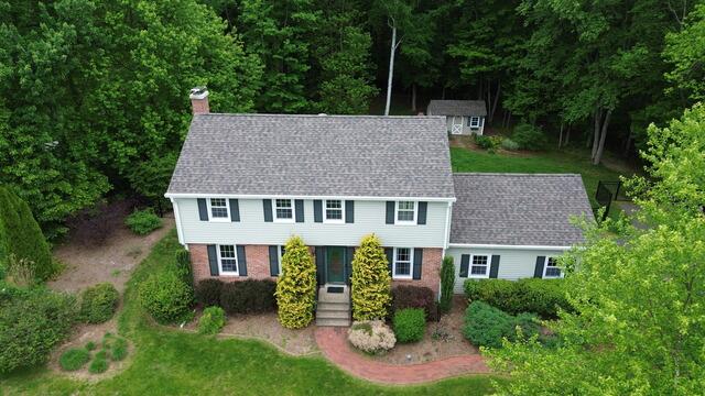 This photo highlights the completed roof featuring IKO Dynasty shingles in the color Driftshake. Not only do these shingles give the home a clean, refreshed look, but they're also built to perform. IKO Dynasty shingles are designed with ArmourZone technology for added nail-holding strength and wind resistance, perfect for standing up to tough Northeast weather. With algae-resistant granules and a wide nailing area for secure installation, this roof is more than just beautiful. It's a durable, long-lasting investment in the home's protection.