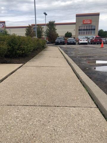 Note the pronounced height disparity between the concrete slabs, indicative of settlement and posing a clear pedestrian tripping hazard.