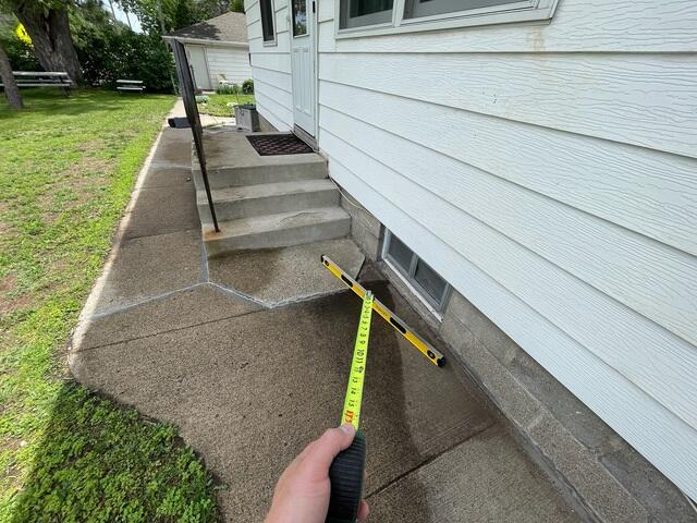 Before: The sidewalk around the steps have begun sinking causing the area to become bumpy and uneven.