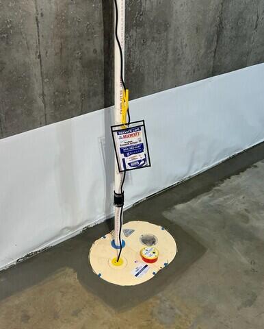 The CleanSpace vapor barrier lines the wall 2ft up to corral water from the wall into the WaterGuard drainage system which lines the floor's perimeter collecting groundwater. All of that water is channeled into the SuperSump Plus sump pump and sent out of the home through the discharge line.