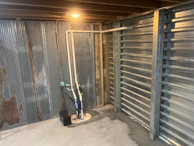 A photo of our Sump Pump system installed alongside the EverBrace. Any collected water will be fed into this pump and sent outside the basement. In cases of heavier water intrusion/flooding, or even a power outage, the sump pump is backed up by an additional pump, and another battery-powered pump.