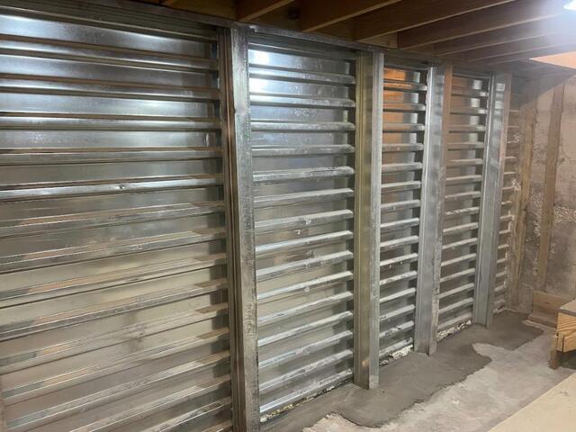 This photo showcases the completed EverBrace system. The homeowner chose to leave the reinforced panels as they were, but if anyone is not a fan of this look and prefers something more finished looking, we can also cover the EverBrace with DryWall!
