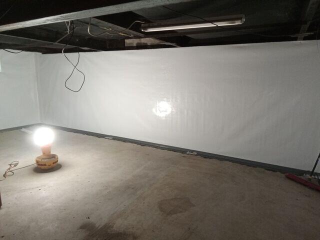 The after photo shows a dried out space, with debris removal, and the Liberty Basement Systems waterproofing products in place.