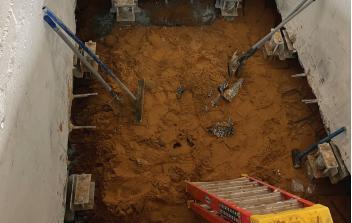 Retrofit piers and brackets installed with floor removed
