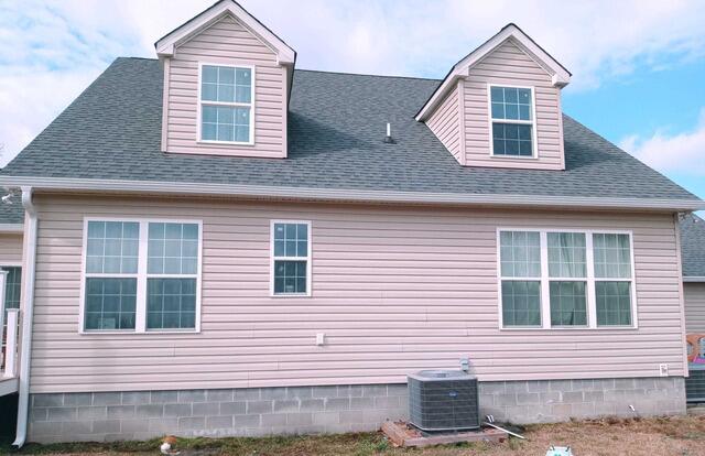 Gutter Shutter with downspout installed along the side of the home.