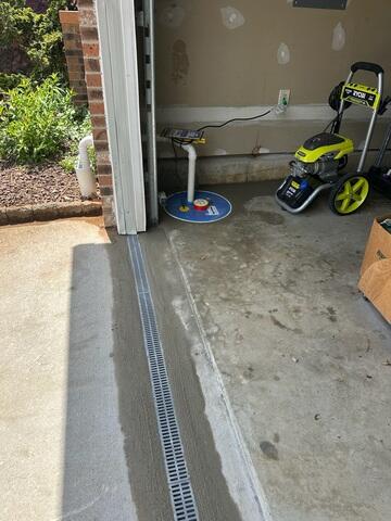 To stop surface water from entering through vulnerable areas like doorways and stairwells, we installed our TrenchDrain system. Its grated design captures water at ground level and channels it directly into the drainage system.