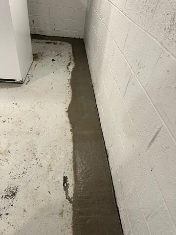 WaterGuard was installed to prevent basement flooding by collecting water at the foundation's edge and channeling it to a sump pump, keeping the basement permanently dry.