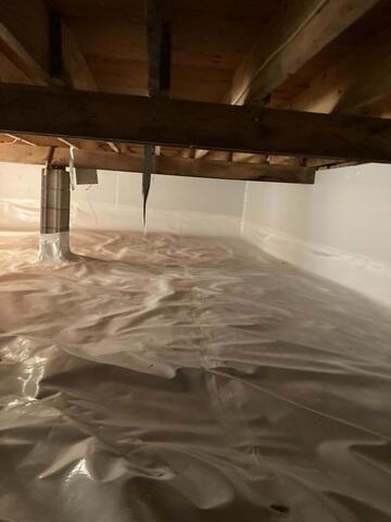 During: Emmanuel and his crew attached CleanSpace to the unfinished basement walls.