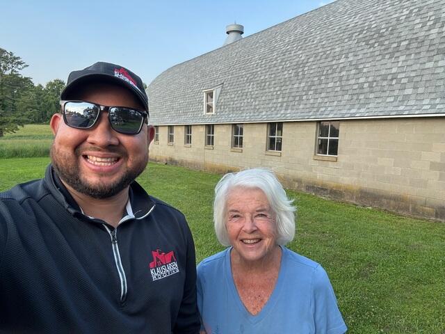 Here's Mary with Diego, our on-site Project Manager, who was there every step of the way during her roof replacements. Diego worked closely with Mary, answering all her questions and making sure she felt confident in every part of the process. From her home to both barns, she had a great experience with our team, and now all three roofs are fully protected and looking beautiful. The Klaus Roofing Way!