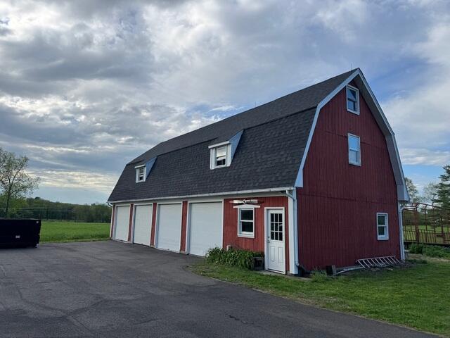The finished barn looks completely transformed with its brand new IKO Dynasty shingles in Granite Black. The stunning new shingles give it a polished, fresh look, and you'd never guess a full roof replacement just happened. Every scrap of debris was cleared, leaving the surrounding area spotless. It's a fresh start for the barn and peace of mind for Mary, no more picking up fallen shingles with the 130 MPH Wind Warranty IKO Shingles! These are not going anywhere!