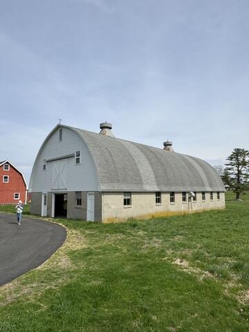 Now, Mary was ready to replace her last structure, the barn. This before shot shows just how badly the barn needed a new roof. Shingles were missing across the surface, and you can clearly see the streaks from years of weather damage. After every storm, shingles would end up scattered on the ground, and it was time for a long-lasting solution.