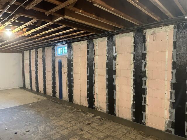 The finished CarbonArmor installation blends neatly with the basement, providing strength without bulky hardware or disruption.