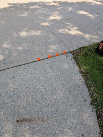 Before: Our Design Specialist, James, recommended installing PolyLevel below the sinking sidewalk.