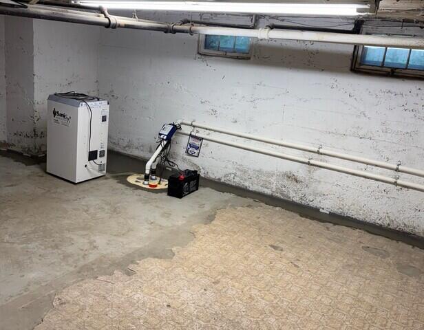 The WaterGuard drainage system is installed along the perimeter of the basement floor and covered in fresh concrete. The SaniDry XP keeps humidity in the basement low and drains itself into the TripleSafe sump pump. The TripleSafe sends all of the water out of the basement through the discharge lines.
