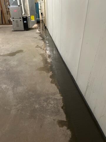 The crew installed WaterGuard along the edges and restored the flooring with cement