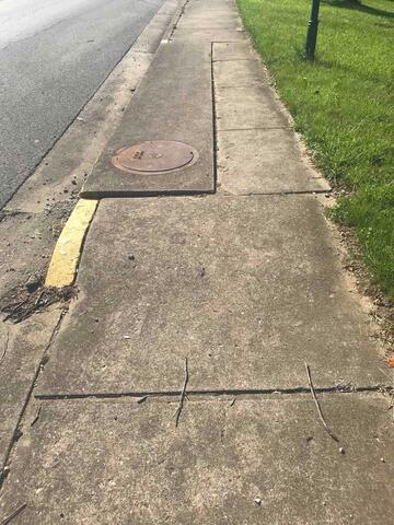 Spot 4 - Before Photo: You can tell this is the same spot as the "Spot 4 - After Photo" due to the yellow paint spot near the manhole cover.