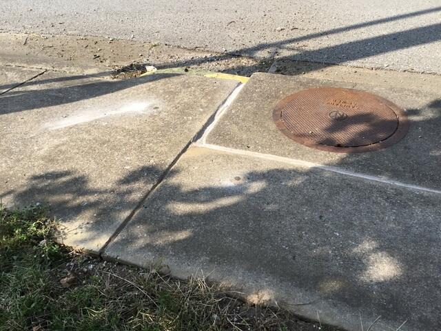 Spot 4 - After Photo: We raised the two slabs adjacent to the manhole cover by a couple inches to level everything back out.