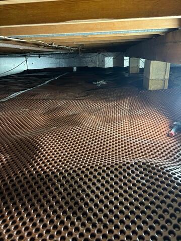 The crew also added our Drainage Matting to create a clear path for water to flow beneath the vapor barrier, helping prevent puddling and enhancing the effectiveness of the entire crawl space waterproofing system.