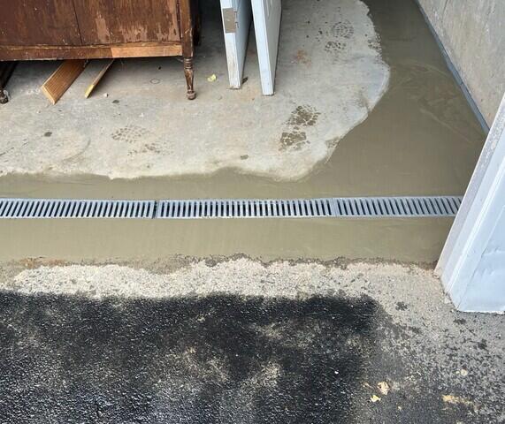 TrenchDrain XL was installed on the inside of the garage door to catch excess and surface water. It is connected to the WaterGuard drainage system.
