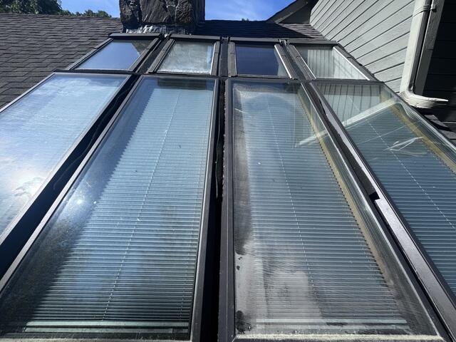 This section of the roof had eight skylights installed side by side, which created a lot of problems over time. With so many skylights crammed into one area, the gutters between them were too narrow to handle water flow. Leaves and debris would collect quickly, causing constant clogs and putting the roof at risk of leaks. The homeowner was stuck with the hassle of frequent upkeep just to keep water moving properly.