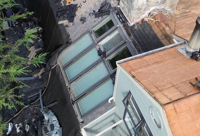 Here's the start of the transformation. Our crew began removing shingles around the section with eight skylights, preparing to take on the toughest part of this project.