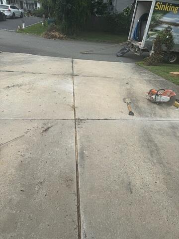 To restore this sunken driveway, our crew injected PolyLevel Foam beneath the concrete slabs. As the foam expanded, it filled hidden voids in the soil and gently lifted the slabs back to a level position, eliminating tripping hazards and preventing further settlement.