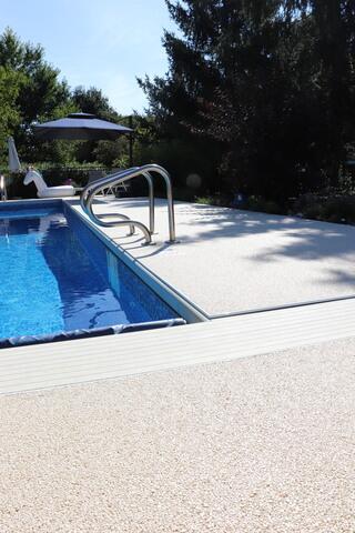 The new Sugar Lake Durastone overlay creates a seamless, high-end look around the pool, combining beauty and durability.