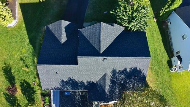 Aerial photo of a large residential roof in Newark, Delaware after a complete Klaus Roofing System installation with durable IKO Dynasty shingles in Granite Black.