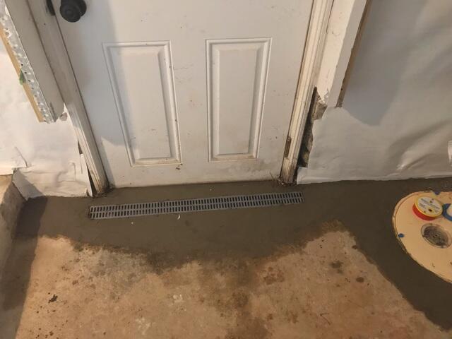 A trench drain installed to stop water from entering the home's basement entryway then it would be pumped out by the Triple Safe Sump.