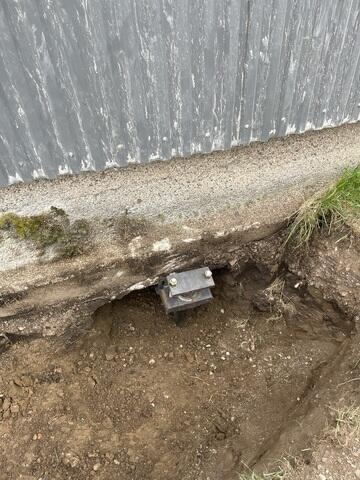 During: Our Foreman, Aaron, and his crew successfully secured seven Helical Piers along the shed foundation.