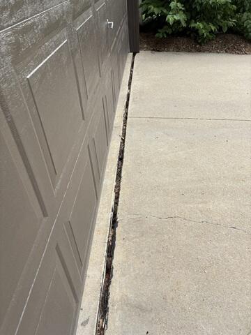 The gap that had formed between the driveway and garage