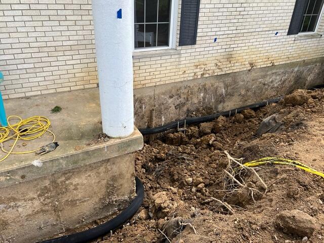 In this photo you can see the exterior French drain, which we carefully worked around during excavation to avoid any damage.