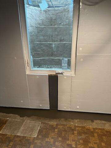This close up shows our RockWell egress well. The well contains natural looking stairs, mimicking real stone. The window can be cranked open and is sealed properly. Egress windows are required by code for basements with bedrooms.