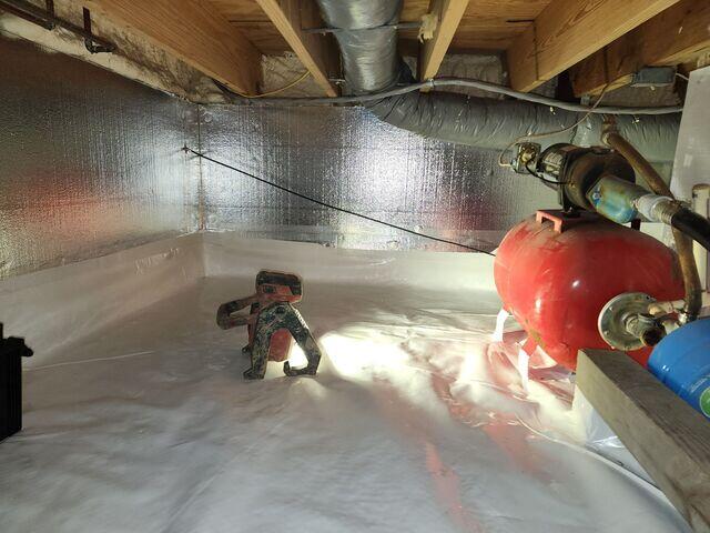 In this photo you can see the SilverGlo insulation panels along the walls of the crawl space. You may also be able to notice the spray foam insulation we injected onto the rim joists.