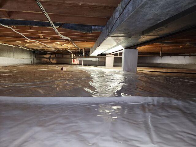 Underneath the vapor barrier on the floor in this crawl space is our Terrablock floor insulation. Its puncture-resistant, and durable enough for access. It also makes the crawl space super comfortable to crawl across. It has an R-3.2 insulation rating.