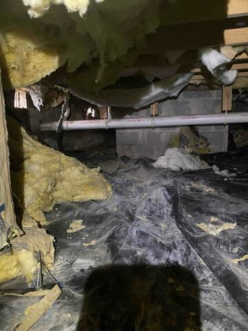 This is what the crawl space looked like before we repaired it. Fiberglass was drooping from the ceiling, moisture was running rampant, and the floors above the space were very cold in the winter.