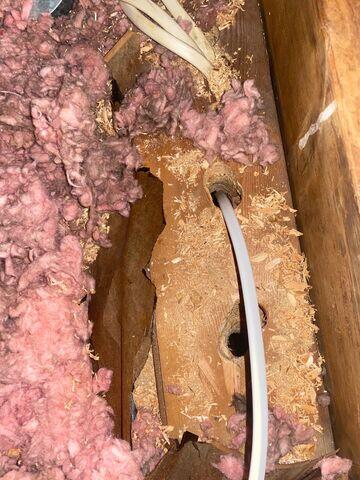 This is the top of a wall underneath the insulation. Lots of air leaks out of those wiring holes as well as around the edges of the wooden top plate the holes are drilled thru. They've got to be sealed before insulation can be added.
