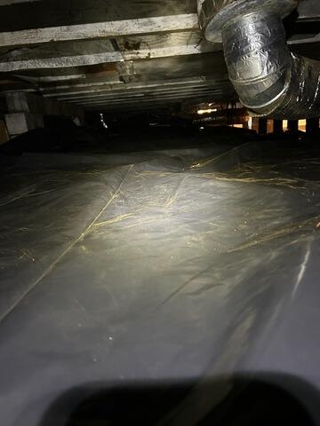 After removing 9 cubic yards of dirt from the space, we installed our 6 mil vapor barrier to prevent moisture from making its way up through the floor.