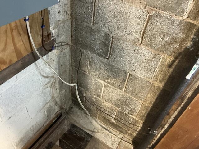 The efflorescence on the Cinder Block walls shows that there is a moisture issue.