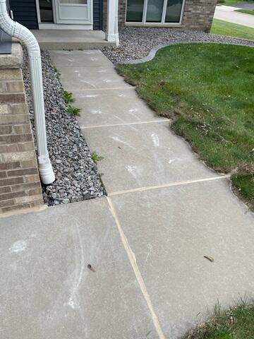 After: Our Foreman, Jordan, and his crew successfully lifted the sidewalk back to its original position.