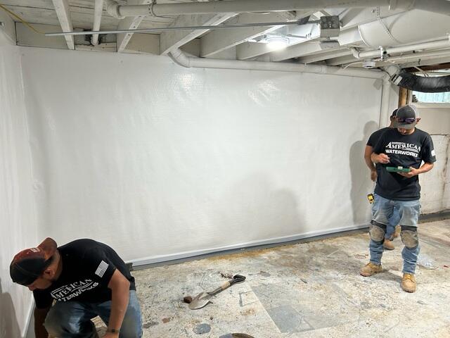 During: The crew attached CleanSpace to the walls and is in the process of installing WaterGuard