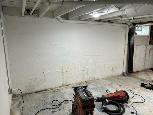 Before: Water can be seen leaking along the walls and edges of the flor