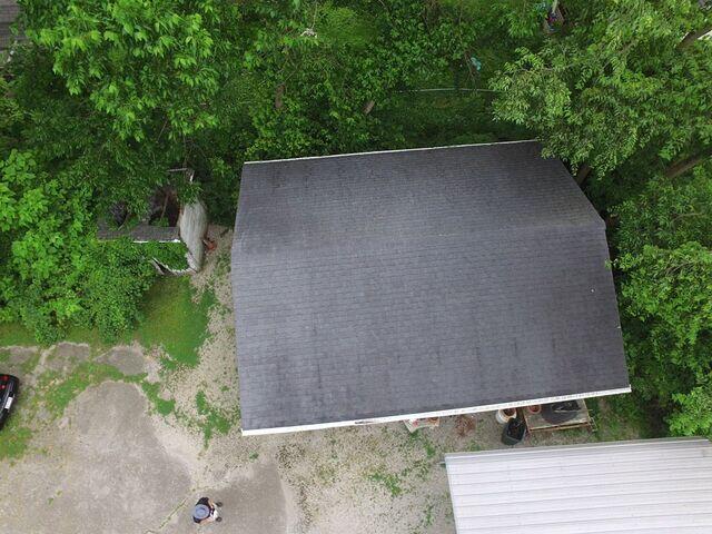 This photo taken upon the inspection shows the old roof on their shed.