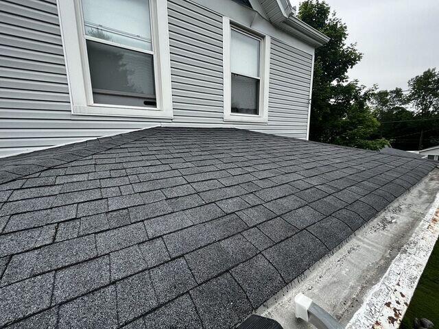 This photo was also taken upon the initial inspection and it shows a close up of the shingles, as well as the deteriorating box gutters.