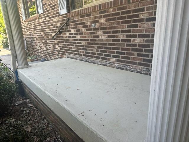 The porch slab showed cracking and signs of settlement, pulling away from the foundation.