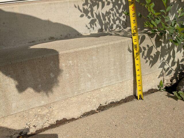 A close up to see how far the slabs have sunken in front of the step