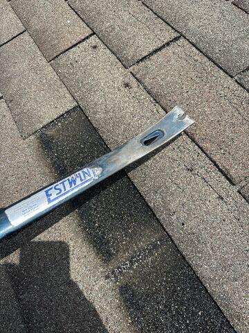 After we received the shingles the insurance company sent over, our Inspector then documented the process of the patch repair. He started with a flat bar to reduce the lift on the existing shingles when installing the patch.